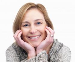 photo_dental_-_woman_in_sweater_smiling_with_face_in_hands_11-1-2012