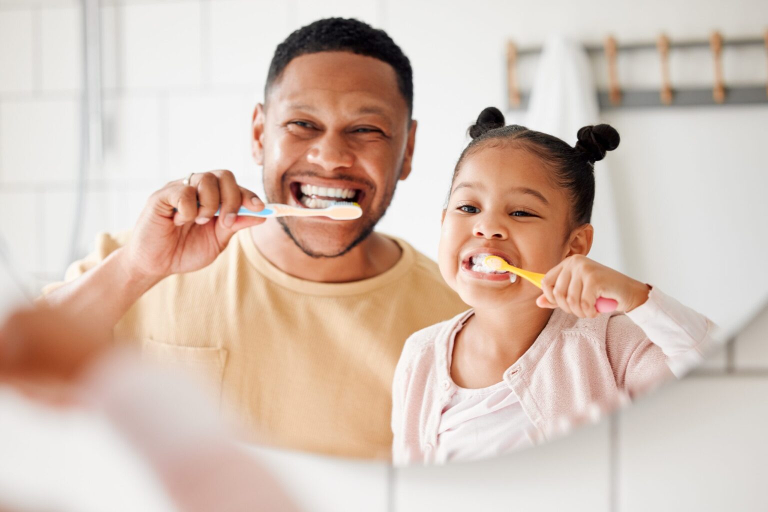 father and daughter brushing their teeth in Toms River