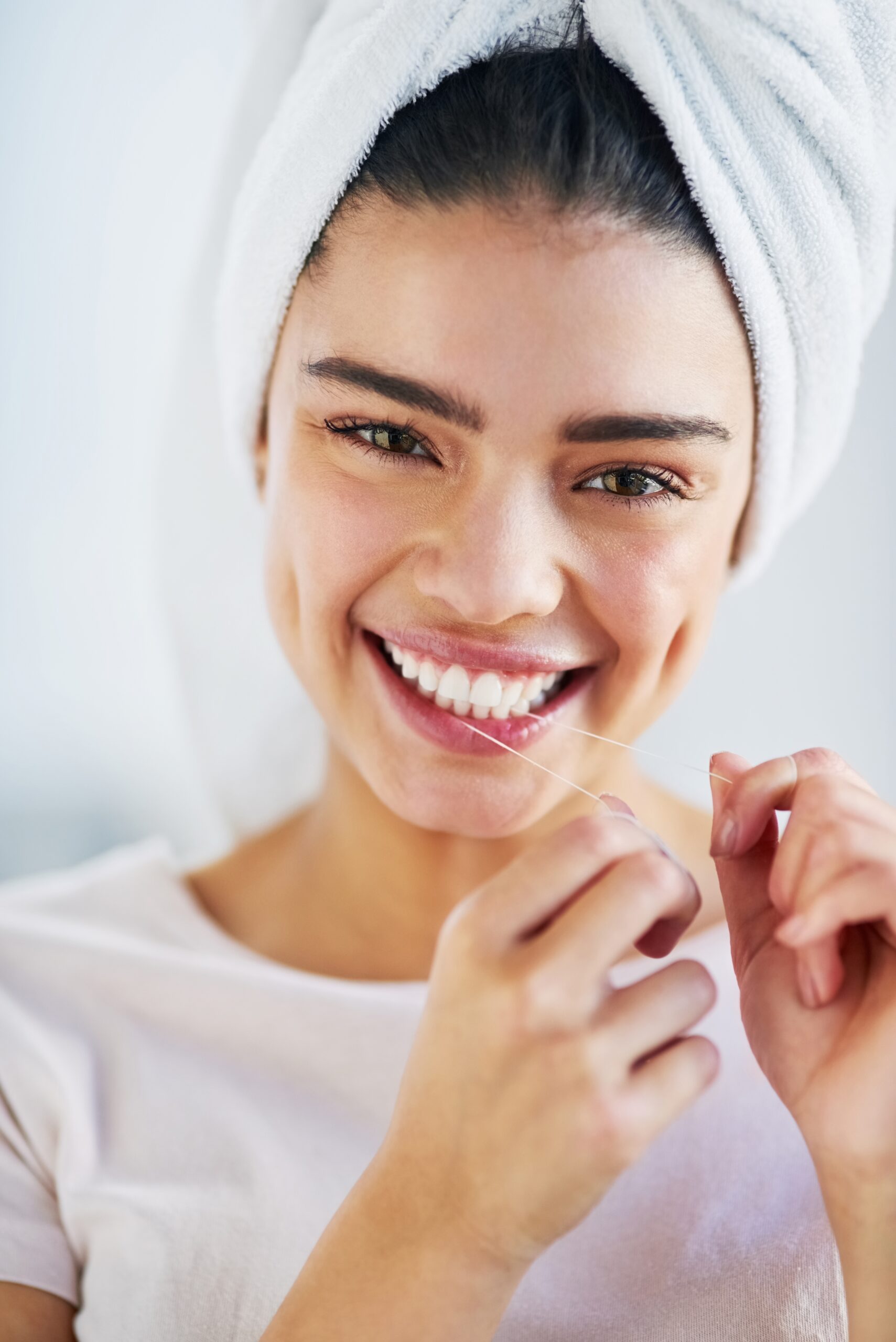 young woman smiling confidently, showing her perfect white smile